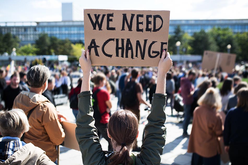 Rear view of people with placards and posters on global strike for climate change. A rear view of people with placards and posters on global strike for climate change.