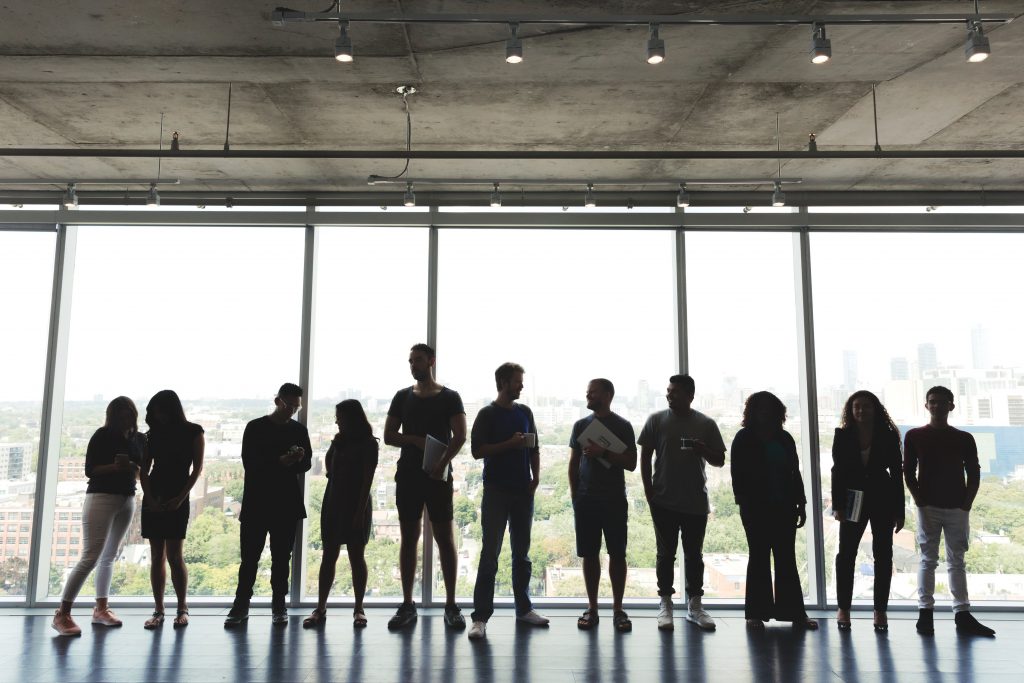 large-group-standing-in-office large-group-standing-in-office