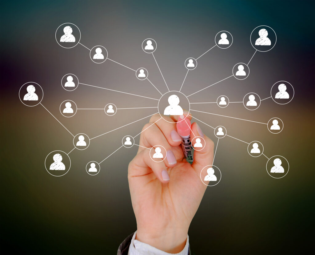 Businessman drawing a social network on virtual screen Businessman drawing a social network on virtual screen